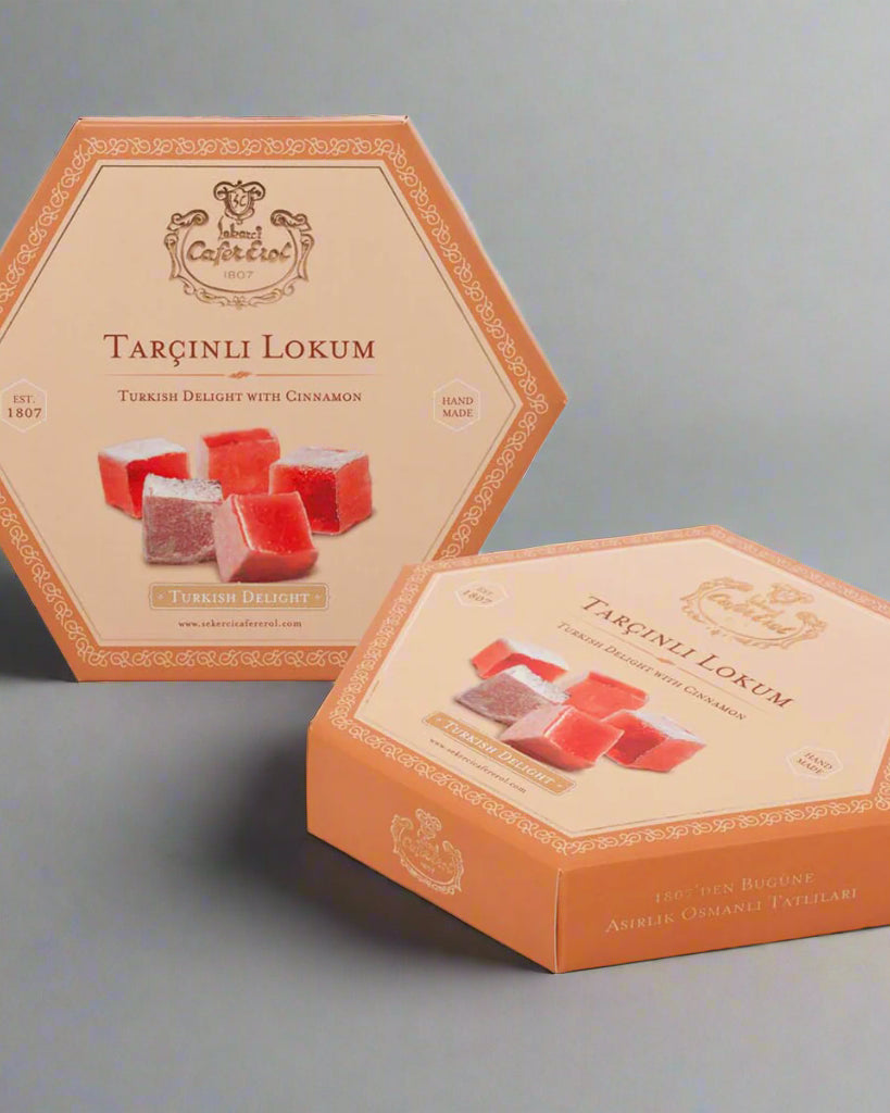 A carton box of Turkish delight candy with cinnamon flavor, presented in an open-sided box with a visual display window showing the red and green colored candies inside.