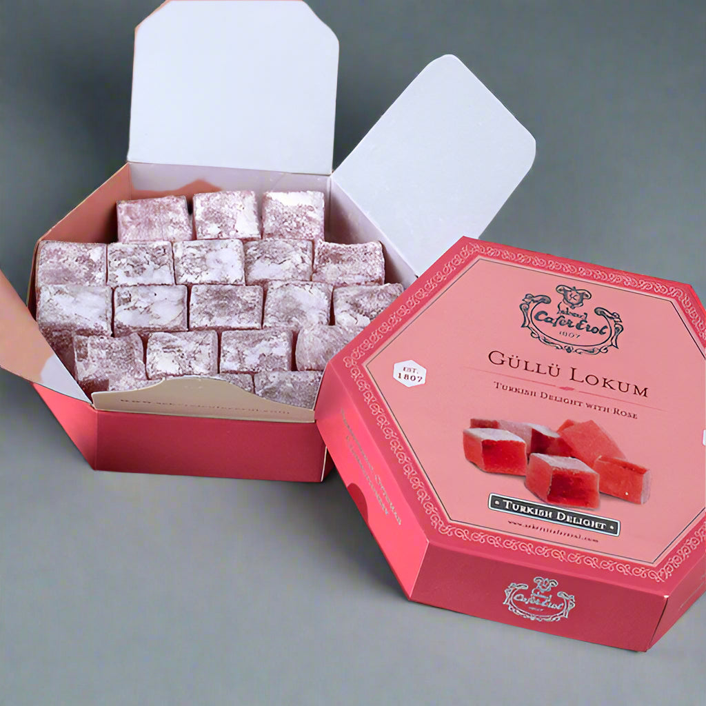 A box of rose-flavored Turkish delight cubes in a hexagonal shape, with the branding and product details visible on the packaging.