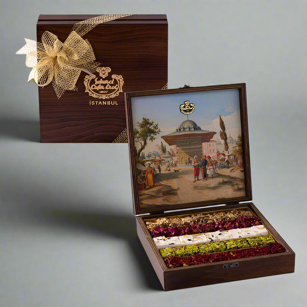A wooden box with a painted scene of Istanbul on the lid, containing special Turkish delight. The box is adorned with a golden bow and is open, displaying the delicately arranged sweets.