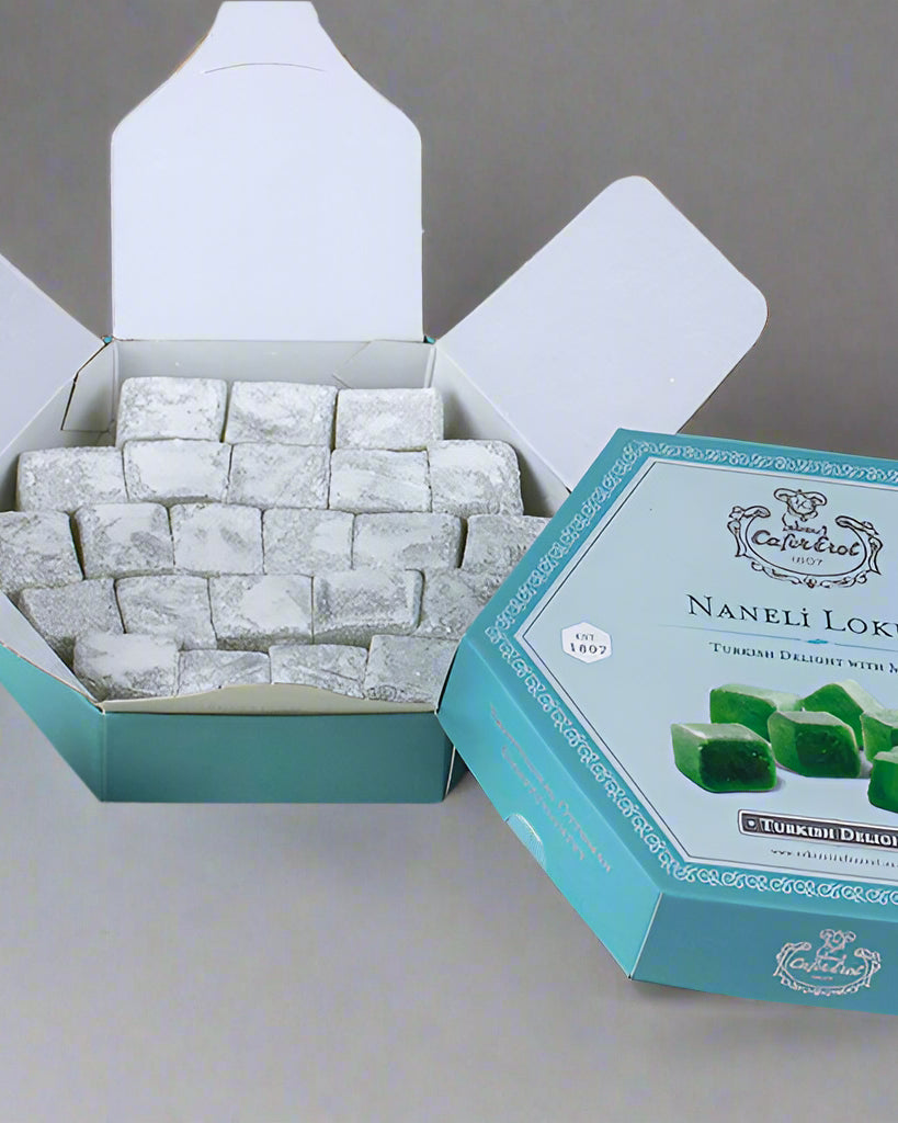 A hexagonal box of Mint Turkish Delight by Çekerci Cafer Erol, displaying the product with visible green mint-flavored candies and an open lid on a marble surface.