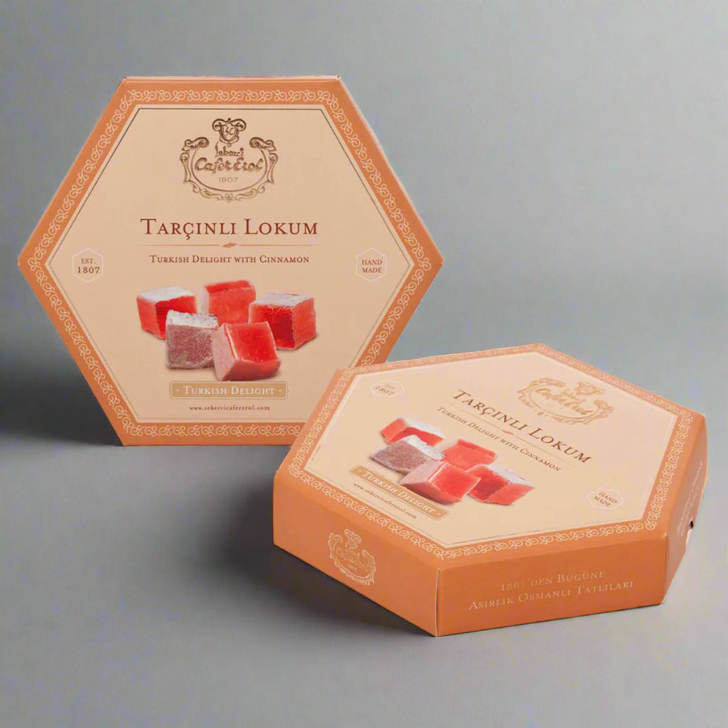 A carton box of Turkish delight candy with cinnamon flavor, presented in an open-sided box with a visual display window showing the red and green colored candies inside.