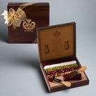 A wooden box of Special Turkish Delight with a knife, the box is open showing various snacks inside and a pair of utensils lie on the side.