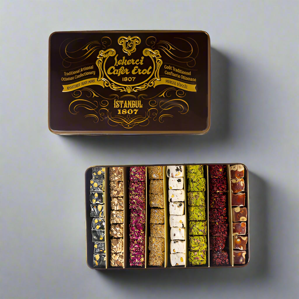 A tin box of Mixed Roll Turkish Delight with rose, lemon, and pistachio flavors, featuring a decorative cover with gold details and the brand name Çekerci Cafer Erol.